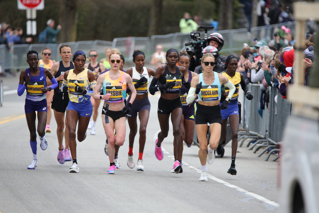 Jess McClain, right, runs in the lead pack on the Boston Marathon course in Newton, Mass., on Monday, April 20, 2026. (AP Photo/Jennifer McDermott)