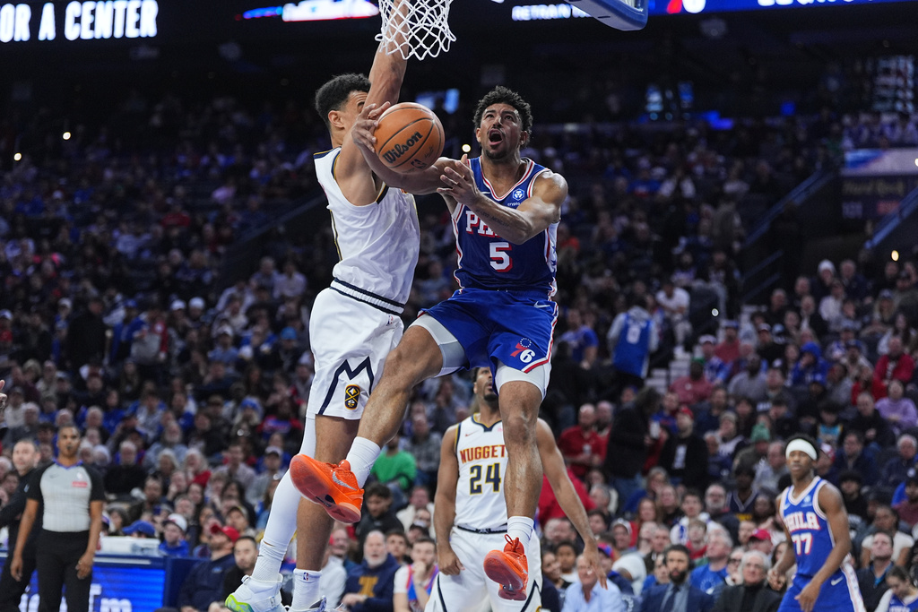 Denver Nuggets' Hunter Tyson (5) goes up to shoot against Denver Nuggets' Spencer Jones during the first half of an NBA basketball game Monday, Jan. 5, 2026, in Philadelphia. (AP Photo/Matt Rourke)