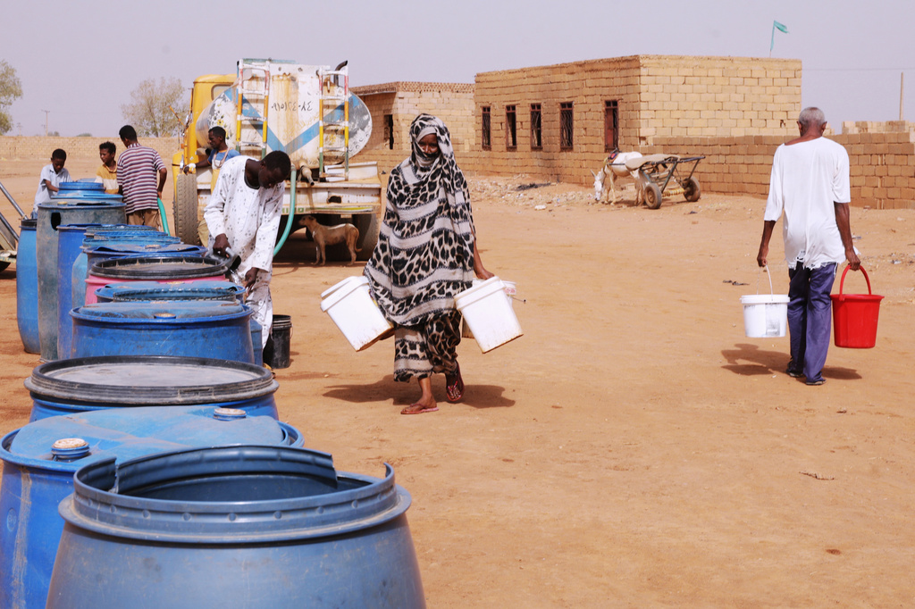 FILE - People fill water containers at a free distribution point amid water outages in Khartoum, Sudan, May 18, 2026. (AP Photo/Marwan Ali, File)