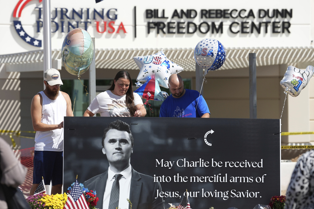 Well-wishers add balloons to a makeshift memorial set up at Turning Point USA headquarters after the shooting death at a Utah college on Wednesday of Charlie Kirk, the 31-year-old founder and CEO of the organization, Thursday, Sept. 11, 2025, in Phoenix. (AP Photo/Ross D. Franklin)