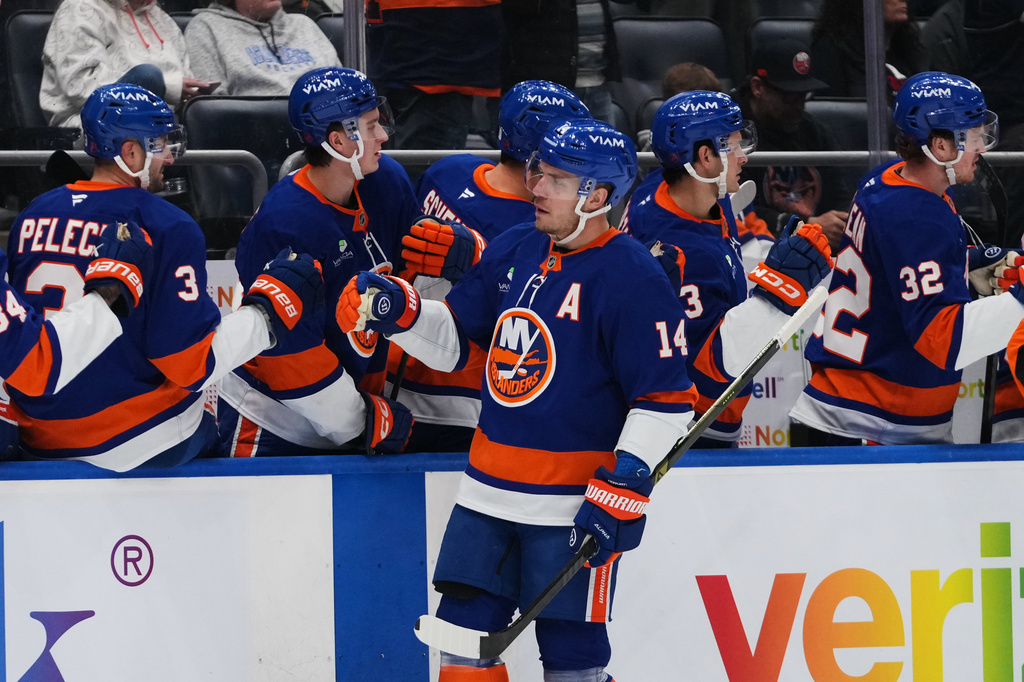 New York Islanders' Bo Horvat (14) celebrates with teammates after scoring a goal during the first period of an NHL hockey game against the Dallas Stars Thursday, March 26, 2026, in Elmont, N.Y. (AP Photo/Frank Franklin II)