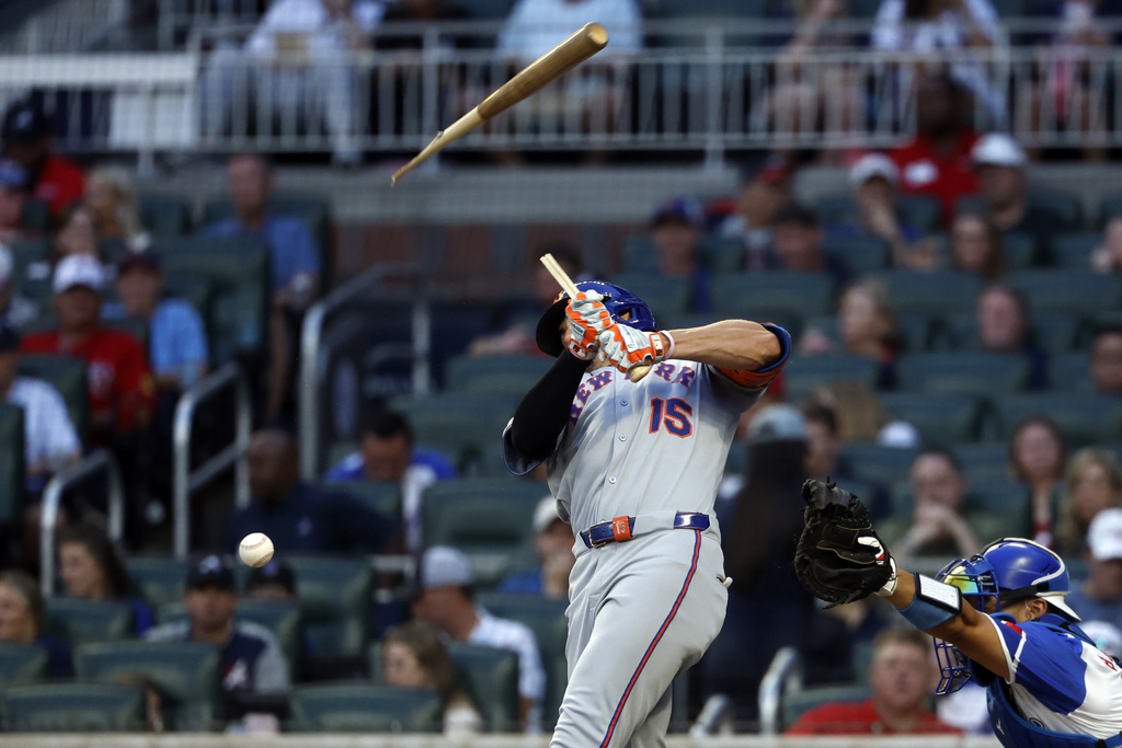 New York Mets' Tyrone Taylor breaks his bat as he hits during the third inning of a baseball game against the Atlanta Braves, Saturday, Aug. 23, 2025, in Atlanta. (AP Photo/Butch Dill)