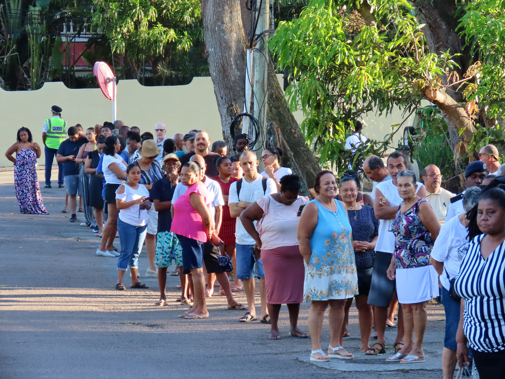 People line up to cast their votes in a runoff presidential election at Mont Fleuri Secondary School, Mont Fleuri, Mahe, Seychelles, Saturday, Oct. 11, 2025. (AP Photo/Emilie Chetty)