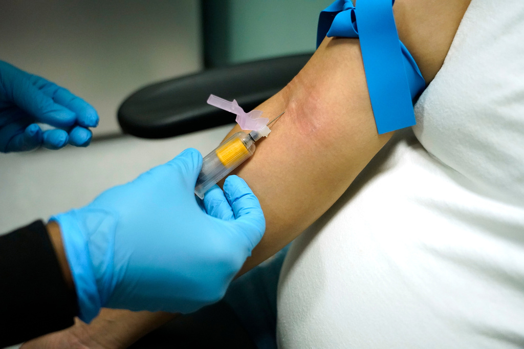 FILE - A technician draws blood at a women's clinic in Jackson, Miss., on Dec. 17, 2021. (AP Photo/Rogelio V. Solis, File)