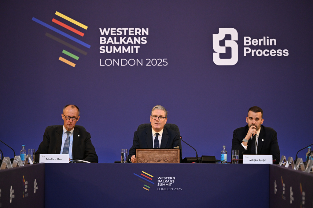 Britain's Prime Minister Keir Starmer, center, flanked by German Chancellor Friedrich Merz, left, and Montenegro's Prime Minister Milojko Spajic, hosts the plenary session of the Western Balkans Summit Western Balkans Summit in London, Wednesday, Oct. 22, 2025. (Chris J Ratcliffe/Pool Photo via AP)
