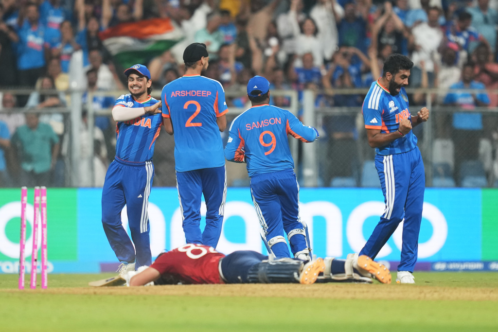 India's Jasprit Bumrah, right, and teammates celebrate the run out of England's Jacob Bethell, on ground, during the T20 World Cup cricket semi-final match between India and England in Mumbai, India, Thursday, March 5, 2026. (AP Photo/Rafiq Maqbool)