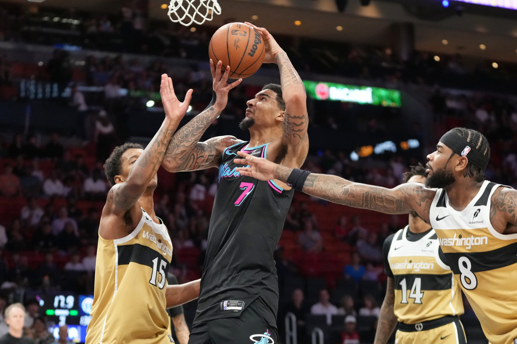 Washington Wizards guard Jaden Hardy (8) and forward Julian Reese (15) defend Miami Heat center Kel'el Ware (7) during the second half of an NBA basketball game Saturday, April 4, 2026, in Miami. (AP Photo/Marta Lavandier)