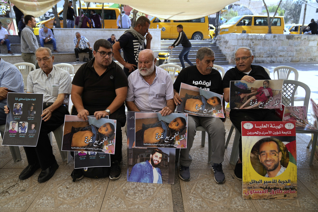 Palestinian activists carry posters that read "no for the starvation of Gaza," during a hunger strike sit-in in the West Bank city of Ramallah, Tuesday, Sept. 16, 2025. (AP Photo/Nasser Nasser)