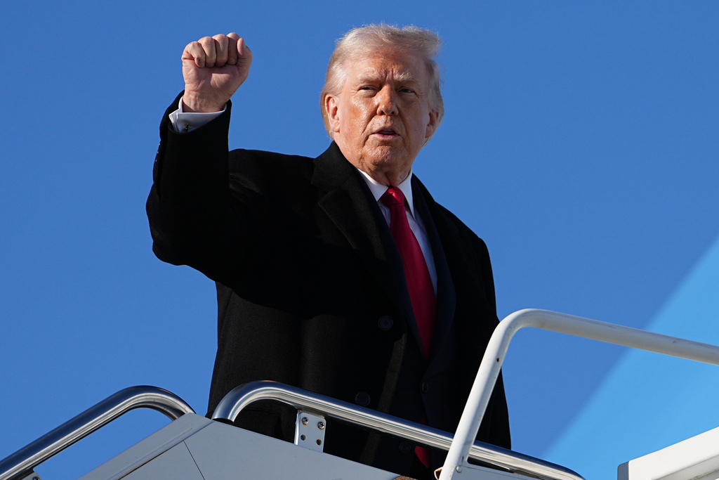 President Donald Trump gestures as he boards Air Force One at Pope Army Airfield, in Fort Bragg, N.C., Friday, Feb. 13, 2026, en route to Palm Beach, Fla. (AP Photo/Matt Rourke)