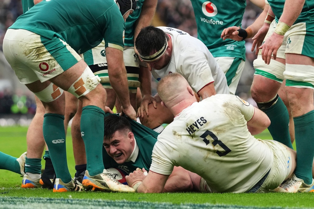 Ireland's Dan Sheehan, center, celebrates after scoring a try during the Six Nations rugby union match between England and Ireland in London, England, Saturday, Feb. 21, 2026. (AP Photo/Alastair Grant)