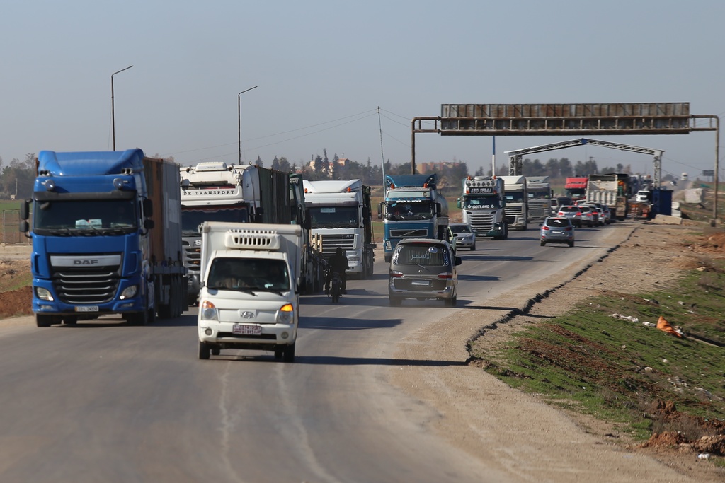 A convoy carrying U.S. Army vehicles drives away from the International Coalition's Qasrak Base, its largest base in northeastern Syria, heading toward Iraqi territory on the outskirts of Qamishli, eastern Syria, Monday, Feb. 23, 2026.(AP Photo/Baderkhan Ahmad)