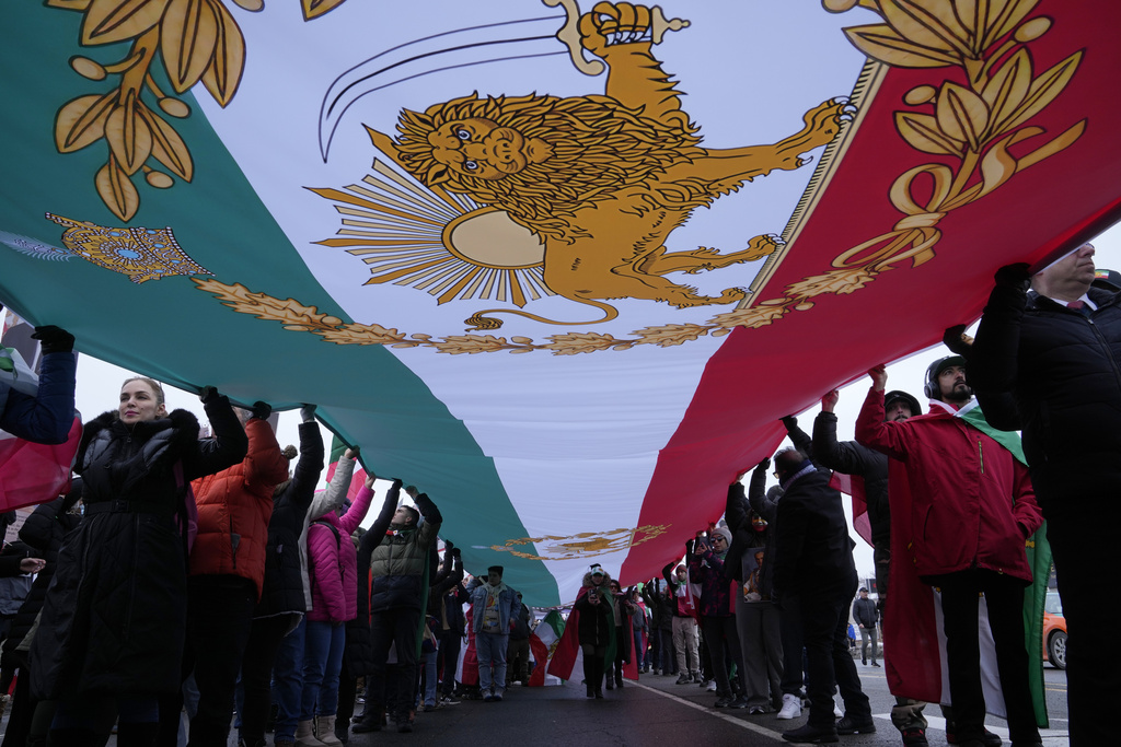Carrying a huge lion and sun flag, supporters of Iran's exiled Crown Prince Reza Pahlavi attend a demonstration in Toronto, Saturday, Feb. 14, 2026. (AP Photo/Kamran Jebreili)