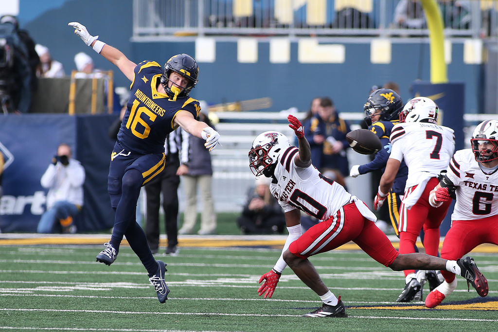 West Virginia wide receiver Jeff Weimer (16) misses a pass while defended by Texas Tech linebacker Jacob Rodriguez (10) during the first half of an NCAA college football game Saturday, Nov. 29, 2025, in Morgantown, W.Va. (AP Photo/Kathleen Batten)