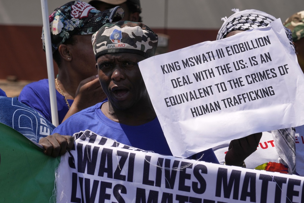 A member of Eswatin Pro-democracy activists, holds a placard at they protest outside the U.S. Embassy in Pretoria, South Africa, Friday, Sept. 19, 2025. (AP Photo/Themba Hadebe)