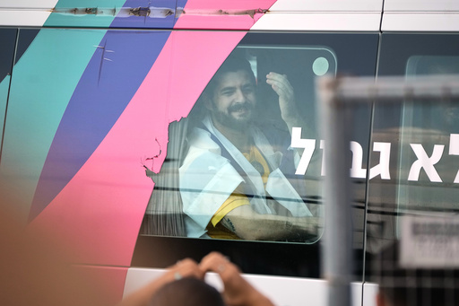 Ziv Berman, an Israeli hostage released from the Gaza Strip gestures from a minibus at the Sheba Medical Center in Ramat Gan, Israel, Monday, Oct. 13, 2025. (AP Photo/Leo Correa) Ziv Berman, an Israeli hostage released from the Gaza Strip gestures from a minibus at the Sheba Medical Center in Ramat Gan, Israel, Monday, Oct. 13, 2025. (AP Photo/Leo Correa)