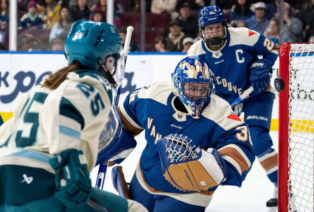 Seattle Torrent's Alex Carpenter (25) hits the post as Vancouver Goldeneyes goaltender Emerance Maschmeyer (38) watches during the second period of a PWHL hockey game in Vancouver, on Tuesday, April 14, 2026. (Ethan Cairns/The Canadian Press via AP)