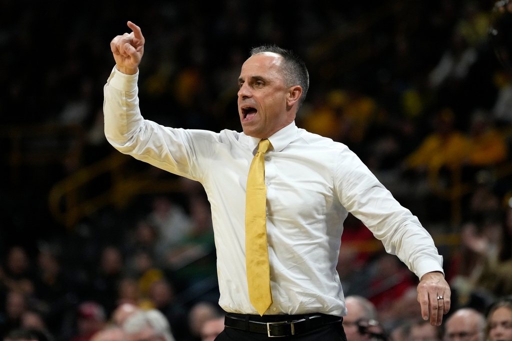 Iowa head coach Ben McCollum directs his team during the first half of an NCAA college basketball game against Maryland, Saturday, Dec. 6, 2025, in Iowa City, Iowa. (AP Photo/Charlie Neibergall)