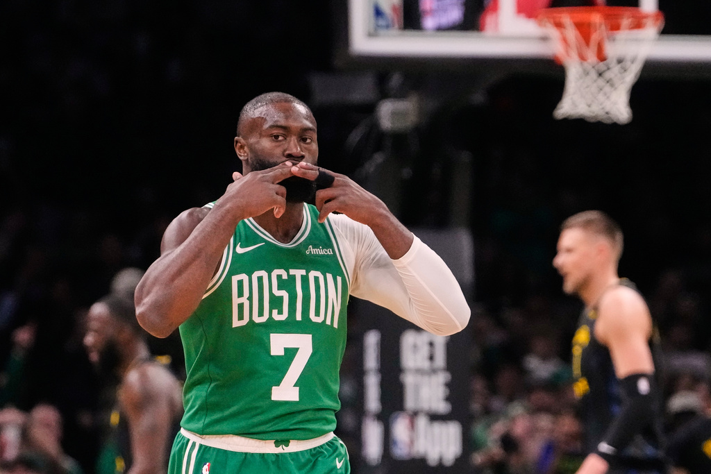 Boston Celtics guard Jaylen Brown (7) blows a kiss to fans after hitting a 3-pointer against the Golden State Warriors during the first half of an NBA basketball game, Wednesday, March 18, 2026, in Boston. (AP Photo/Charles Krupa)