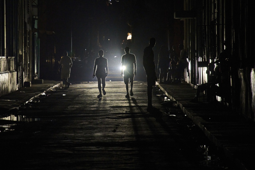 People walk down a street during a blackout in Havana, Wednesday, Sept. 10, 2025. (AP Photo/Ramon Espinosa)