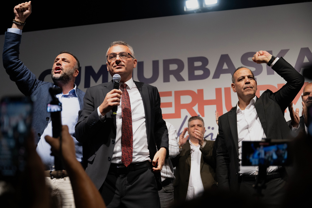 Turkish Cypriot newly elected leader Tufan Erhurman, center, talks to supporters after winning the leadership election in the Turkish occupied northern part of the divided capital Nicosia, Cyprus, Sunday, Oct. 19, 2025. (AP Photo/Nedim Enginsoy)