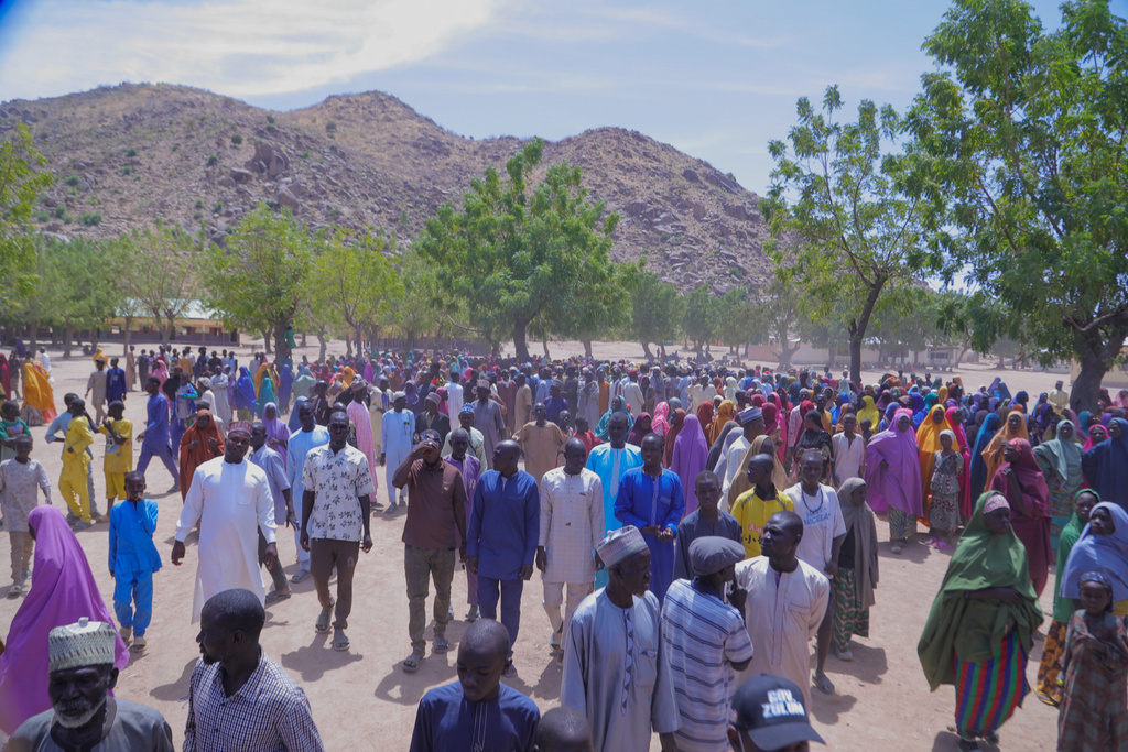 People gather for a meeting with the Borno state governor in Pulka, Nigeria, Friday, March 6, 2026, after they fled an attack by Islamic militants in Ngoshe. (AP Photo/Jossy Ola)