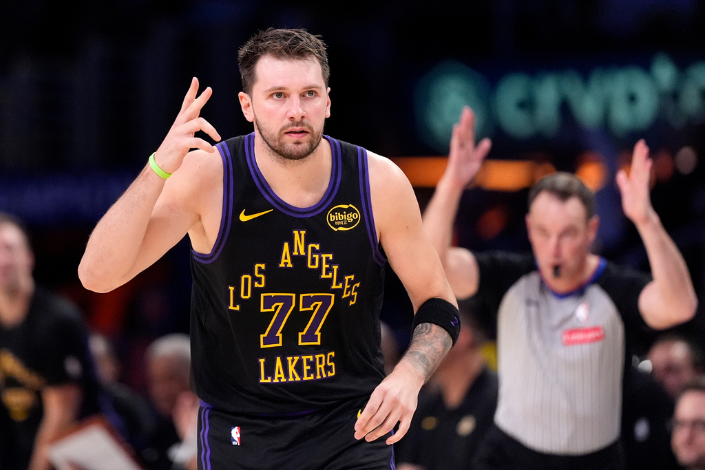 Los Angeles Lakers guard Luka Doncic, left, gestures after scoring during the first half of an NBA basketball game against the New Orleans Pelicans, Tuesday, March 3, 2026, in Los Angeles. (AP Photo/Mark J. Terrill)