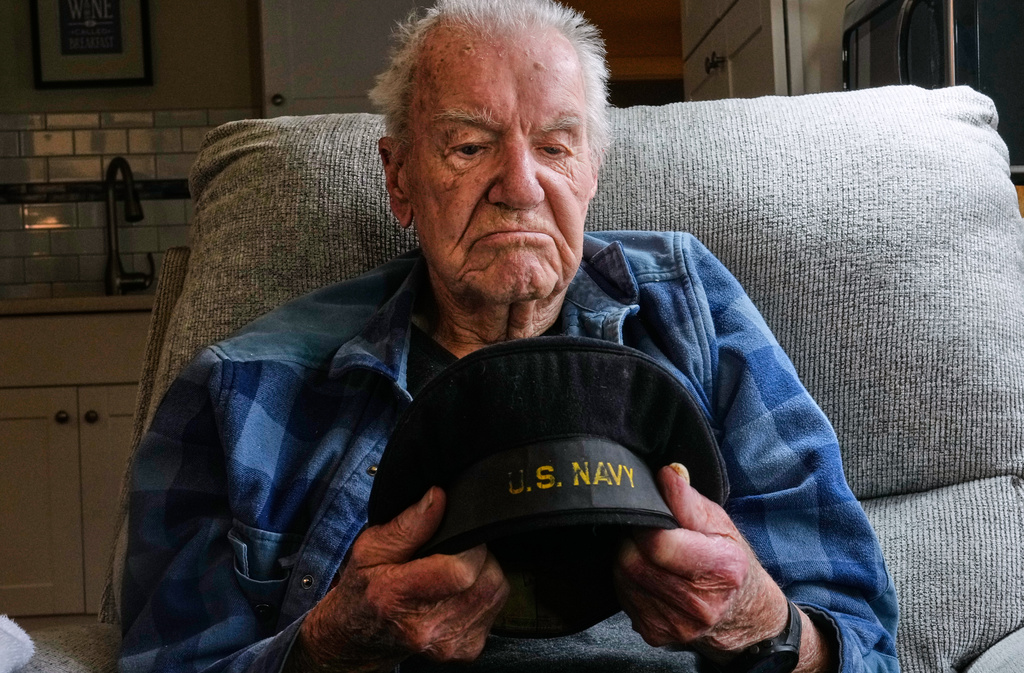 Freeman K. Johnson, a 106-year-old Pearl Harbor survivor, looks down at his flat cap during an interview at his home, May 6, 2026, in Centerville, Mass. (AP Photo/Charles Krupa)
