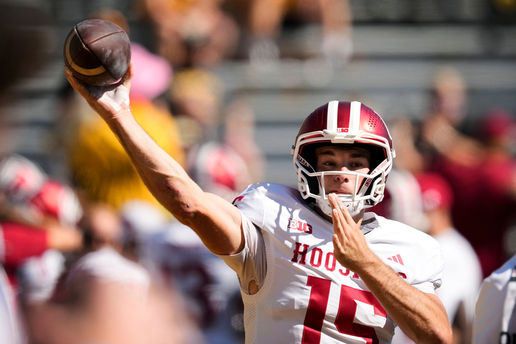 FILE - Indiana quarterback Fernando Mendoza warms up before an NCAA college football game against Iowa, Saturday, Sept. 27, 2025, in Iowa City, Iowa. (AP Photo/Charlie Neibergall, File)