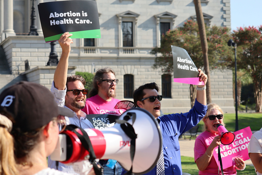 FILE - Over two dozen abortion rights supporters attend a rally outside the South Carolina State House in Columbia, S.C., on Aug. 23, 2023. (AP Photo/James Pollard, file)