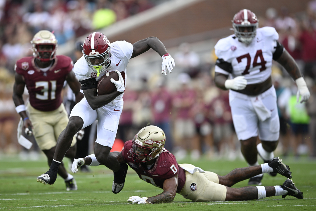 Alabama running back Kevin Riley (28) rushes for yardage past Florida State defensive back Earl Little Jr. (0) during the first half of an NCAA college football game, Saturday, Aug. 30, 2025, in Tallahassee, Fla. (AP Photo/Phelan M. Ebenhack)