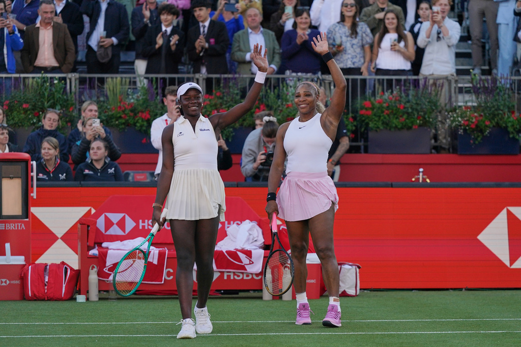 Serena Williams of the United States, celebrates with playing partner Victoria Mboko of Canada after defeating Nicole Melichar-Martinez of Canada and Erin Routliffe of New Zealand during their first round doubles match at the Queen's Club tennis championships in London, Tuesday, June 9, 2026. (AP Photo/Alberto Pezzali)