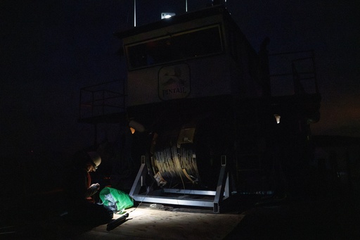 Sam Juber, a graduate student at the University of Washington School of Oceanography, prepares to deploy a 1.3-mile fiber-optic cable to test whether internet cables can detect endangered orca vocalizations near San Juan Island, Wash., Friday, Oct. 10, 2025. (AP Photo/Annika Hammerschlag) Sam Juber, a graduate student at the University of Washington School of Oceanography, prepares to deploy a 1.3-mile fiber-optic cable to test whether internet cables can detect endangered orca vocalizations near San Juan Island, Wash., Friday, Oct. 10, 2025. (AP Photo/Annika Hammerschlag)