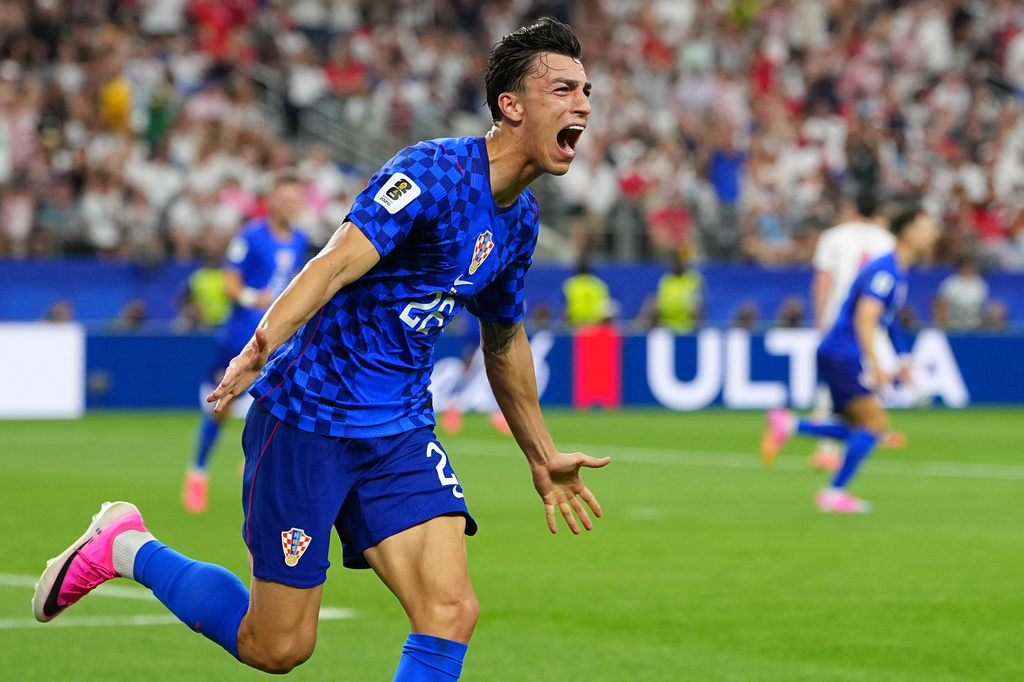 Croatia's Petar Musa celebrates scoring his side's 2nd goal during the World Cup Group L soccer match between England and Croatia in Arlington, Texas, near Dallas, Wednesday, June 17, 2026. (AP Photo/Julio Cortez)