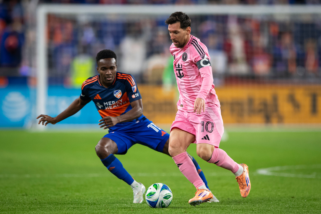 Inter Miami forward Lionel Messi (10) controls the ball as FC Cincinnati forward Corey Baird (11) defends during the first half of MLS soccer's Eastern Conference semifinal Sunday, Nov. 23, 2025, in Cincinnati. (AP Photo/Tanner Pearson)