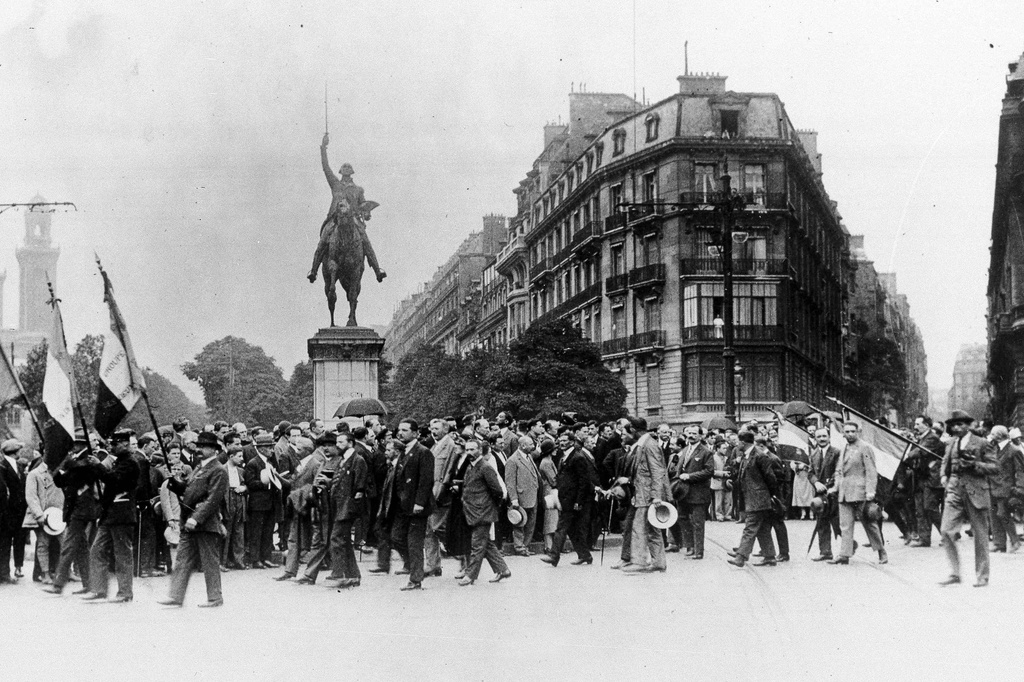 FILE - French war veterans march past the Washington Monument on the Place d'Iena in Paris, on July 19, 1926, in protest against the U.S. debt terms. (AP Photo, File)