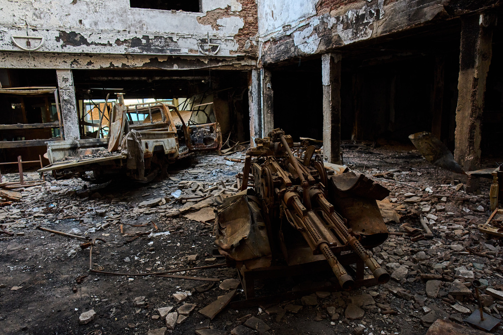 The wreckage of an armored pickup truck is pictured in the lobby of a hotel destroyed during the war in downtown Khartoum, Sudan, Sunday, April 19, 2026. (AP Photo/Bernat Armangue)