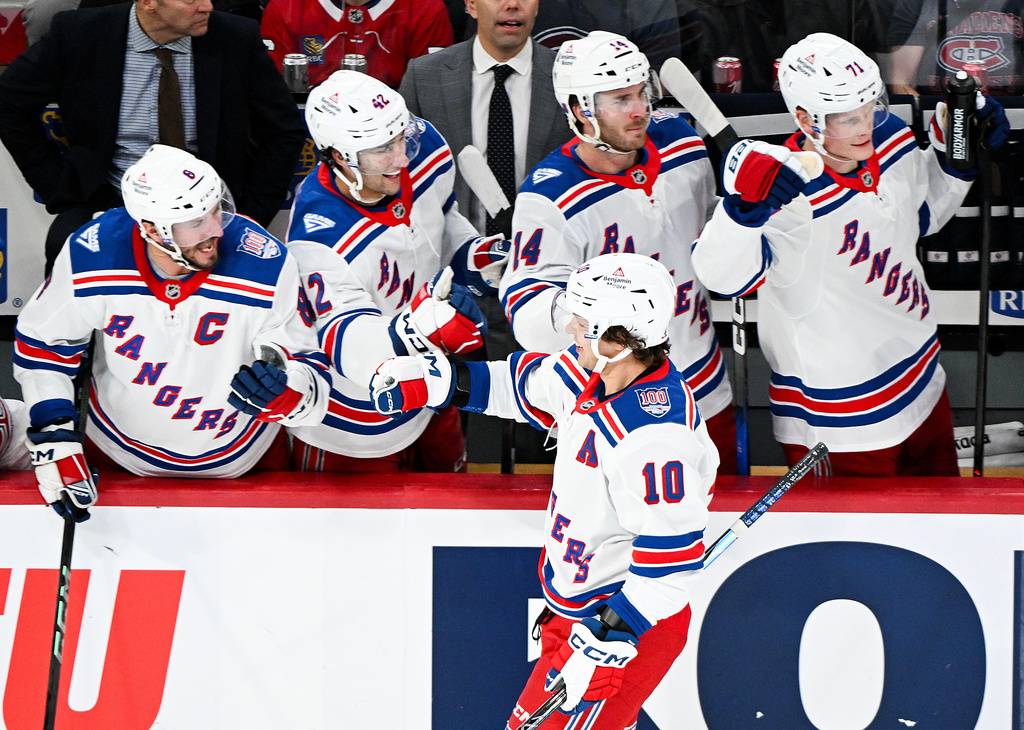 New York Rangers' Artemi Panarin (10) celebrates with teammates after scoring against the Montreal Canadiens during the third period of an NHL hockey game in Montreal, Saturday, Oct. 18, 2025. (Graham Hughes/The Canadian Press via AP)