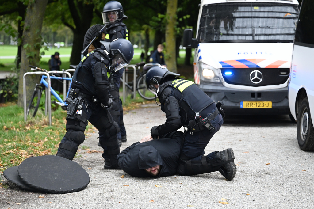 Police officers detain a protester during a far-right groups' protest against immigration and asylum policies, in The Hague, Netherlands, Saturday, Sept. 19, 2026. (AP Photo/Mouneb Taim)