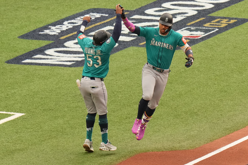 Seattle Mariners' Julio Rodríguez, right, celebrates with first base coach Eric Young Jr. (53) as he rounds the bases after hitting a three-run home against the Toronto Blue Jays during the first inning of Game 2 of baseball's American League Division Series in Toronto, Monday, Oct. 13, 2025. (Chris Young/The Canadian Press via AP) Seattle Mariners' Julio Rodríguez, right, celebrates with first base coach Eric Young Jr. (53) as he rounds the bases after hitting a three-run home against the Toronto Blue Jays during the first inning of Game 2 of baseball's American League Division Series in Toronto, Monday, Oct. 13, 2025. (Chris Young/The Canadian Press via AP)
