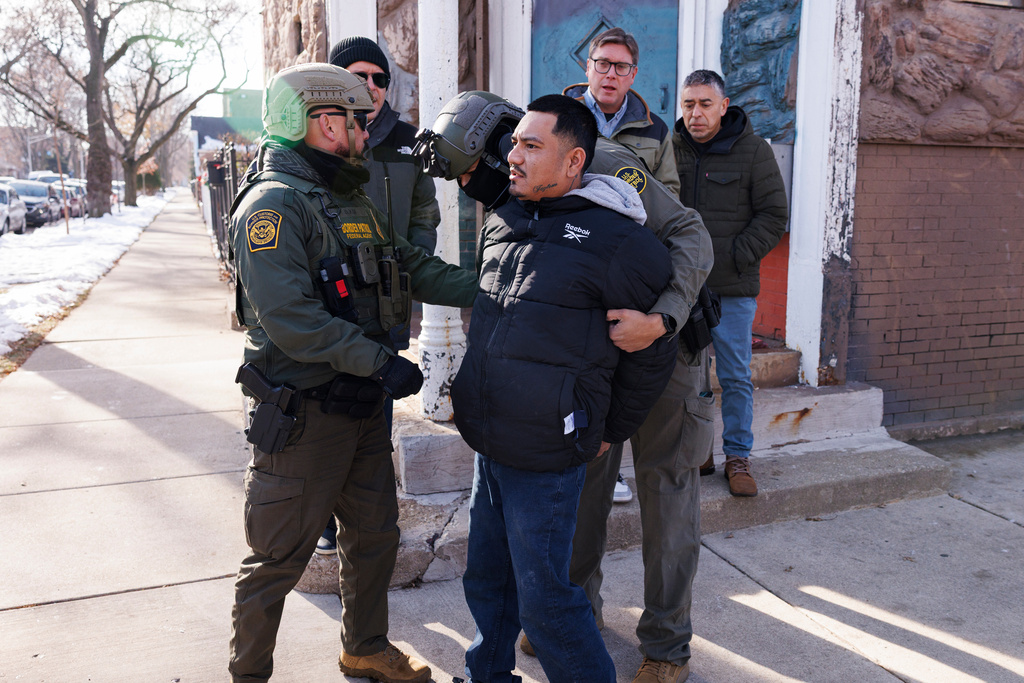 Federal immigration enforcement agents detain an individual near West 27th Street and South Ridgeway Avenue in the Little Village neighborhood of Chicago, Tuesday, Dec. 16, 2025. (Anthony Vazquez/Chicago Sun-Times via AP)