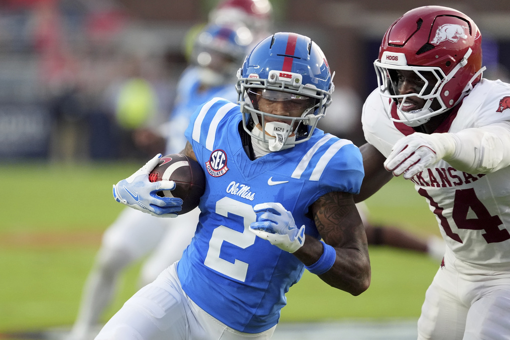 Mississippi wide receiver Harrison Wallace III (2) is pursued by Arkansas linebacker Stephen Dix Jr. (14) after catching a pass for short yard gain during the first half of an NCAA college football game in Oxford, Miss., Saturday, Sept. 13, 2025. (AP Photo/Rogelio V. Solis)