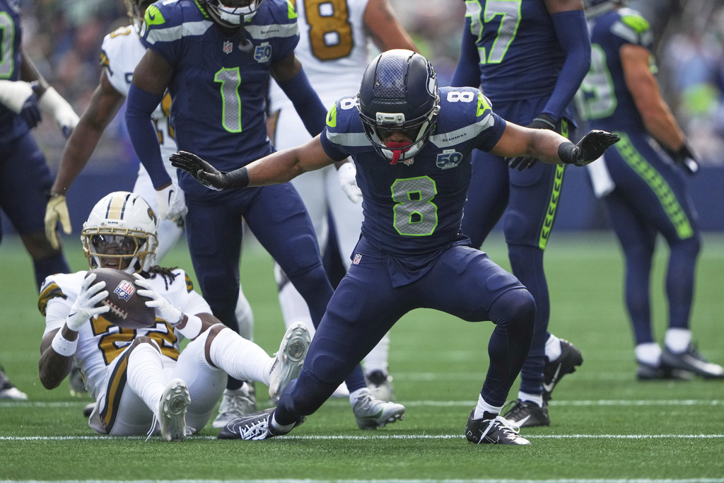 Seattle Seahawks safety Coby Bryant (8) reacts after tackling New Orleans Saints wide receiver Rashid Shaheed (22) during the first half of an NFL football game, Sunday, Sept. 21, 2025, in Seattle. (AP Photo/Lindsey Wasson)