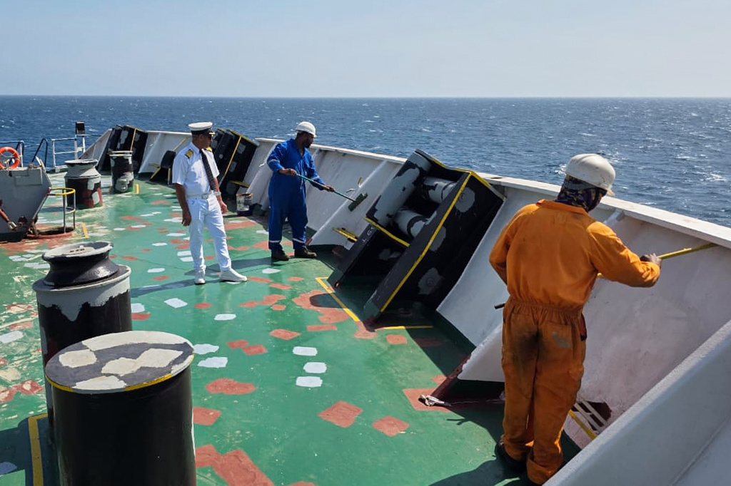 In this picture courtesy of Captain Rahman Al-Jubouri, he, left, supervises sailors on the deck of the Sea Moon oil tanker on the waters the Gulf of Oman, Wednesday, April 15, 2026. (Photo courtesy of Capt. Rahman Al-Jubouri via AP)