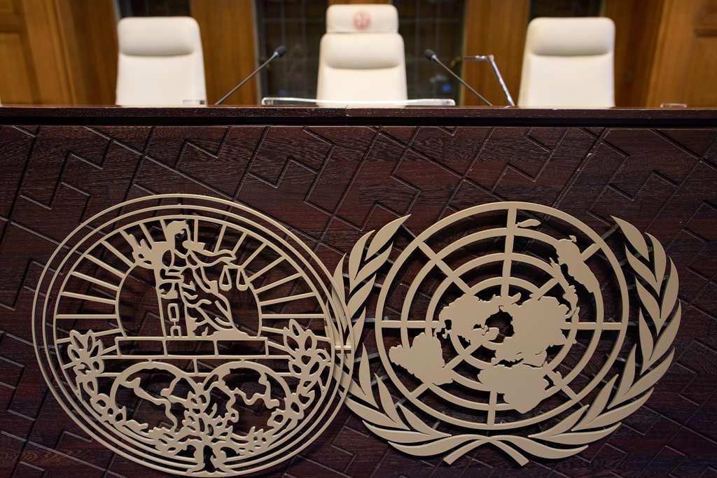 The seat of Presiding Judge Yuji Iwasawa, center, and the World Court logo are seen prior the reading of the advisory opinion of the International Court of Justice on what Israel must do to ensure humanitarian aid reaches Palestinians in Gaza and the occupied West Bank, in The Hague, Netherlands, Wednesday, Oct. 22, 2025. (AP Photo/Peter Dejong)