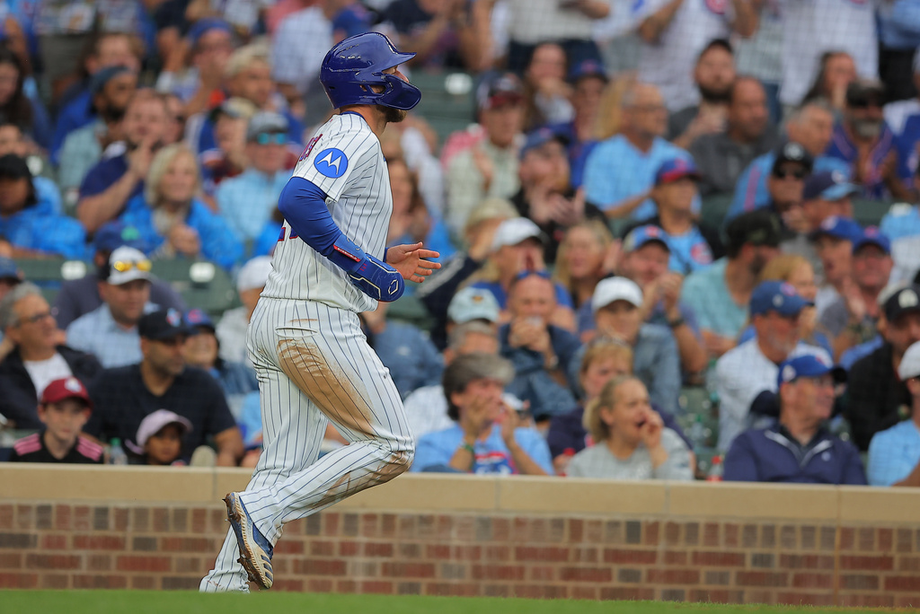 Chicago Cubs' Michael Busch runs to score on a Nico Hoerner groundout to first base during the sixth inning of a baseball game against the Pittsburgh Pirates, Sunday, Sept. 13, 2026, in Chicago. (AP Photo/Melissa Tamez)