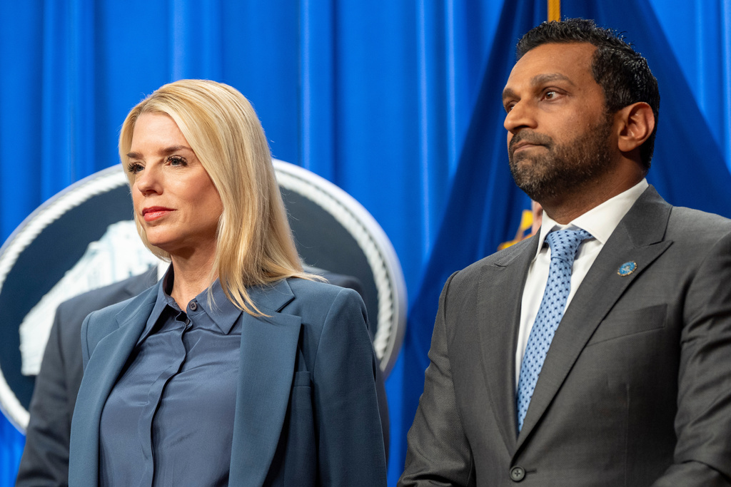 Attorney General Pam Bondi, left, and FBI Director Kash Patel stand during a news conference at the Department of Justice, Thursday, Dec. 4, 2025, in Washington. (AP Photo/Alex Brandon)