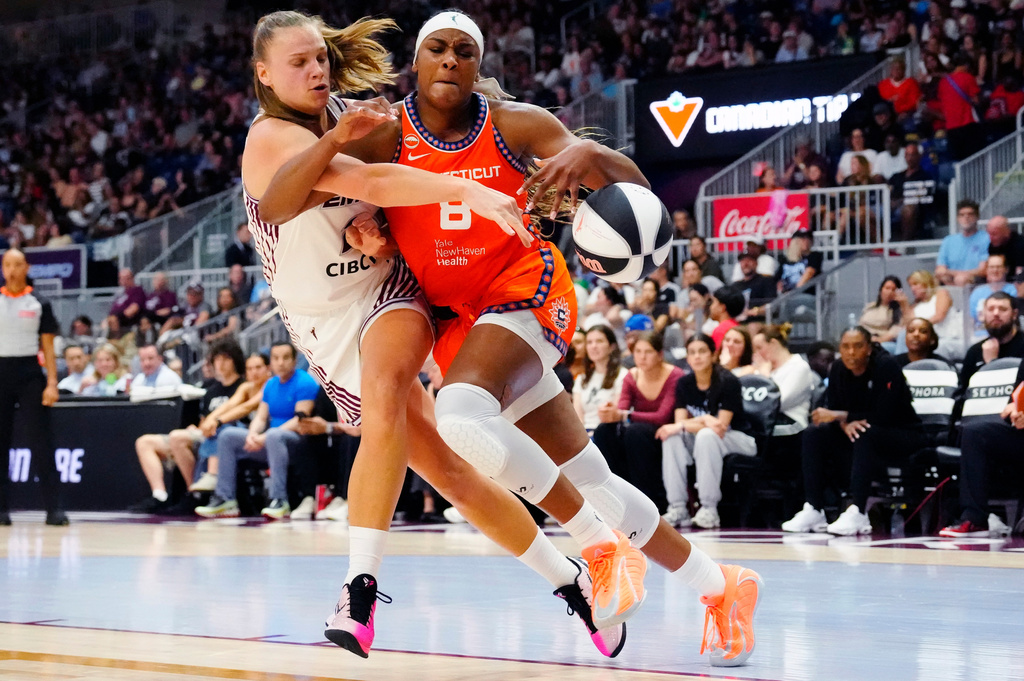 Toronto Tempo's Laura Juskaite (2) fouls Connecticut Sun forward Aaliyah Edwards (8) during the first half of WNBA basketball game in Toronto, Wednesday, June 10, 2026. (Frank Gunn/The Canadian Press via AP)