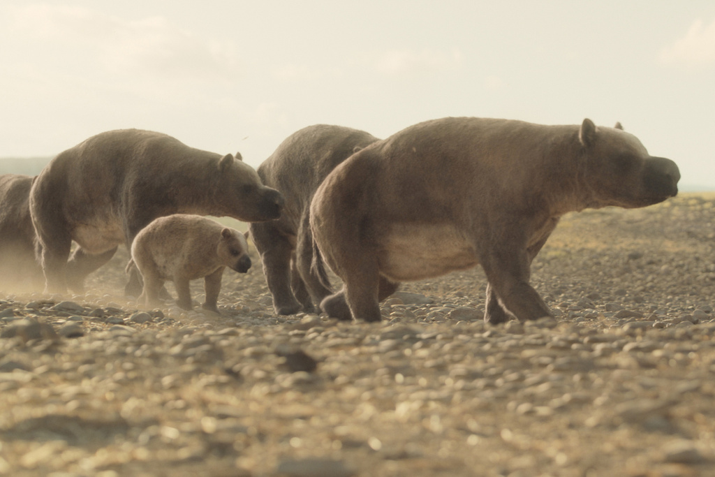 This computer generated image released by Apple TV shows a herd of Diprotodon, rhino-sized relatives of wombats, in a scene from “Prehistoric Planet: Ice Age." (Apple TV via AP)