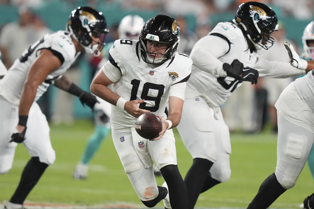 Jacksonville Jaguars quarterback Seth Henigan (19) looks to hand off the football during the second half of an NFL preseason football game against the Miami Dolphins, Saturday, Aug. 23, 2025, in Miami Gardens, Fla. (AP Photo/Lynne Sladky)