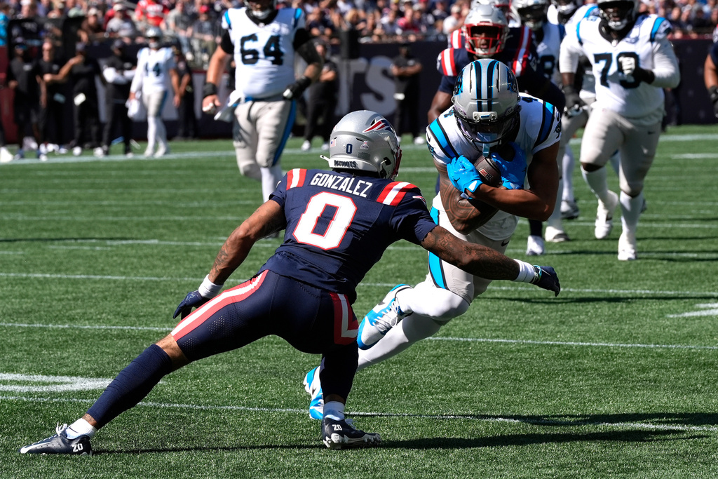 Carolina Panthers wide receiver Tetairoa McMillan (4) runs against New England Patriots cornerback Christian Gonzalez (0) during the first half of an NFL football game, Sunday, Sept. 28, 2025, in Foxborough, Mass. (AP Photo/Charles Krupa)